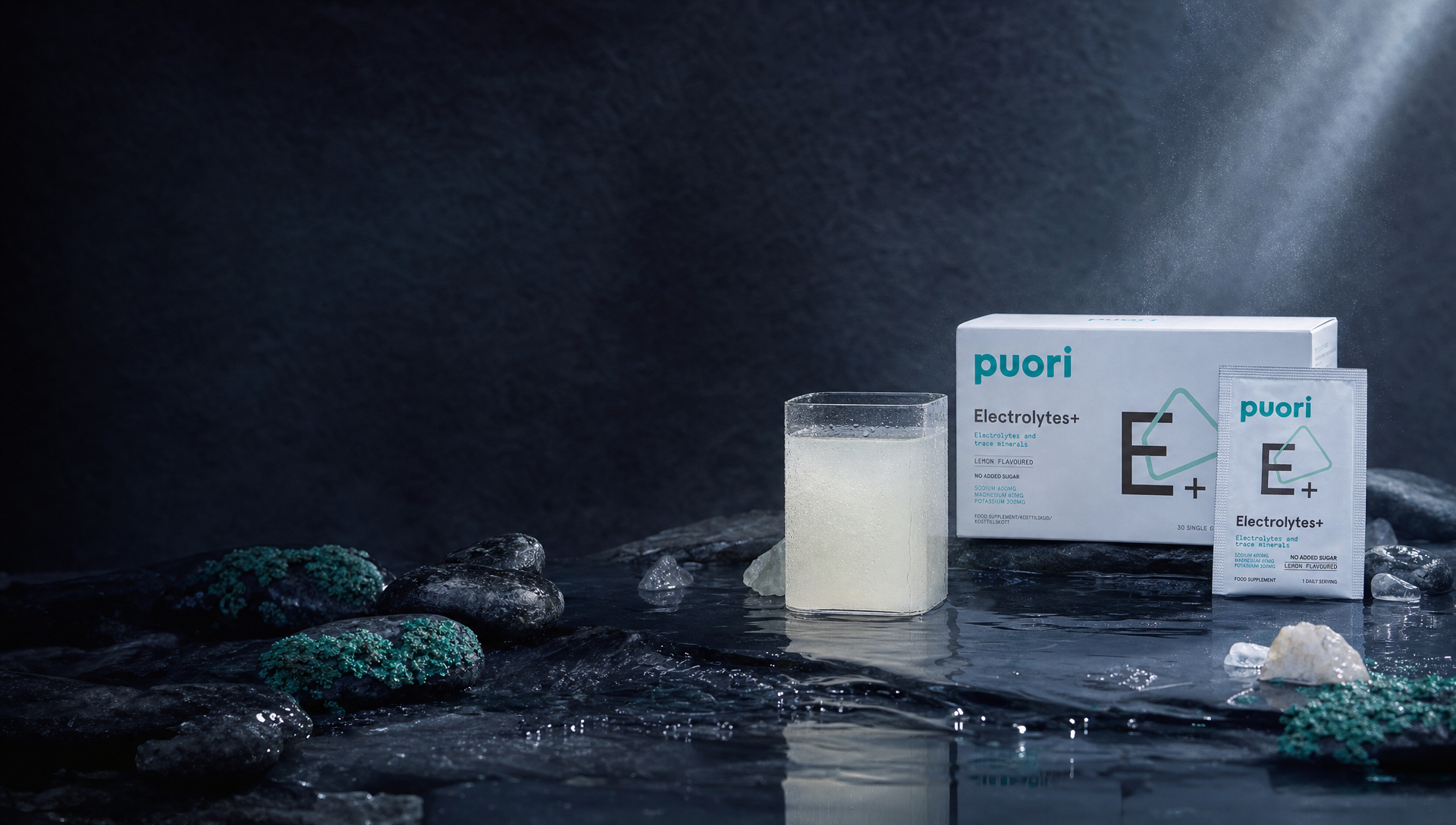 Puori Electrolytes+ with a cold glass, sachet and elemental minerals